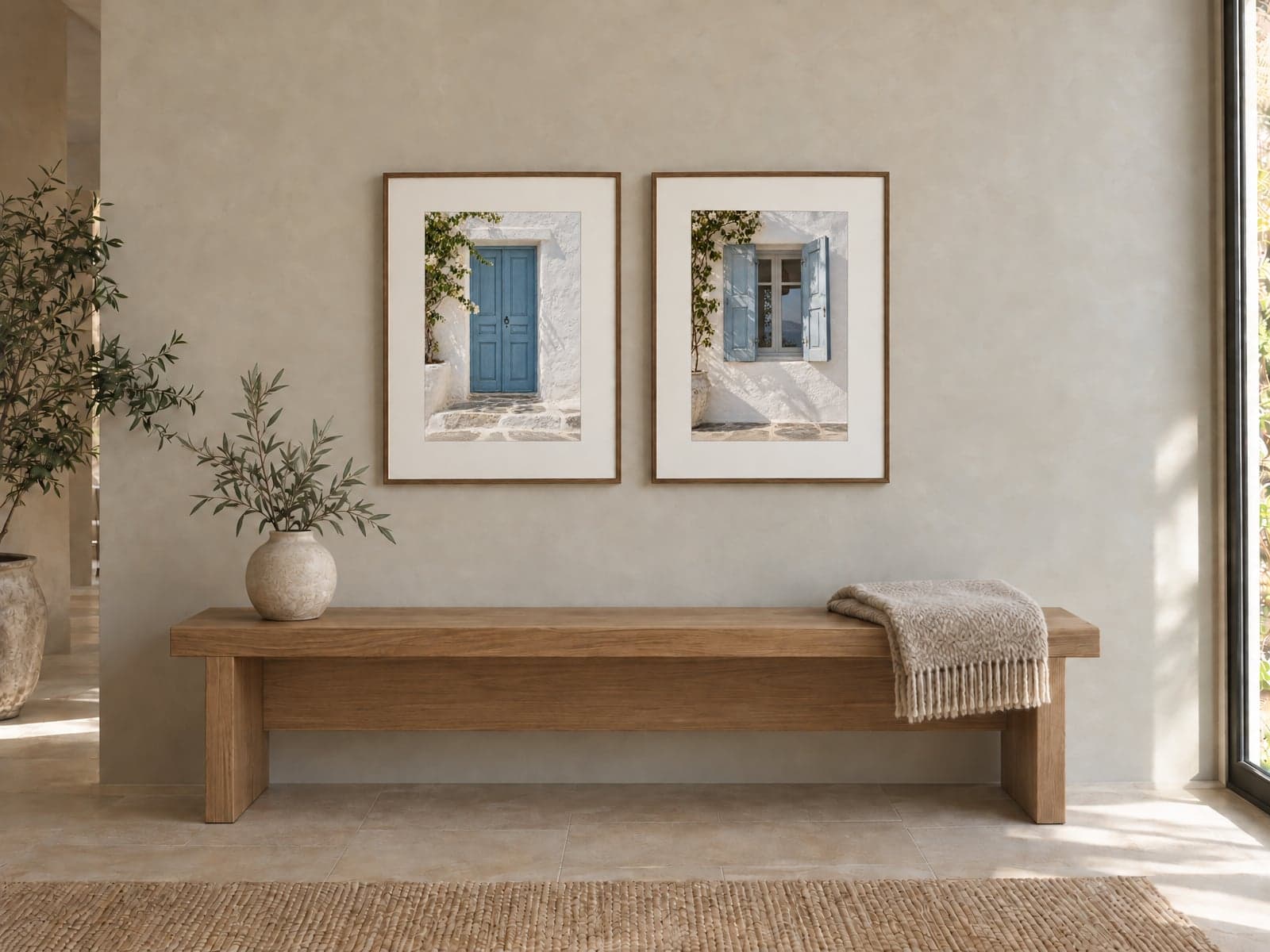 Two framed prints of a blue door and blue shutters above a wooden bench