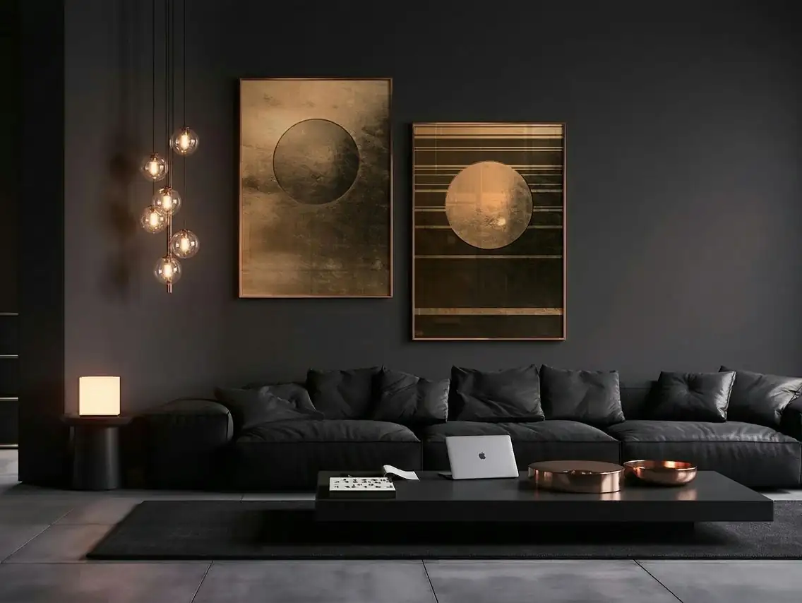 Two large prints above a black sofa in a dark living room