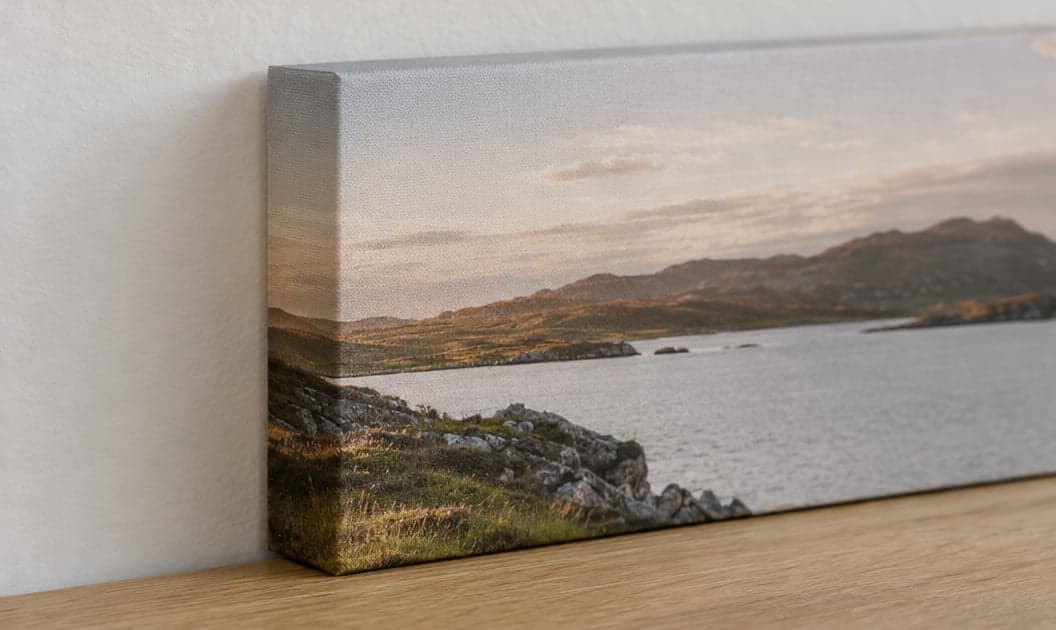 A canvas of a coastline leaning against a wall, its sides mirrored from the picture